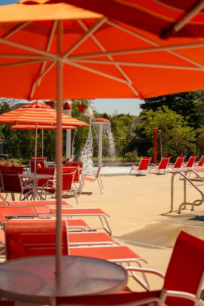 Outdoor pool deck with lounge chairs and umbrellas