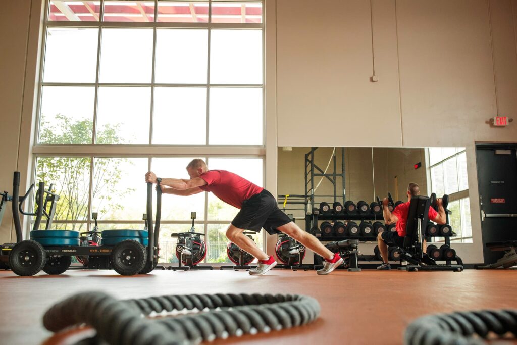 Man pushes weight sled at a fitness center