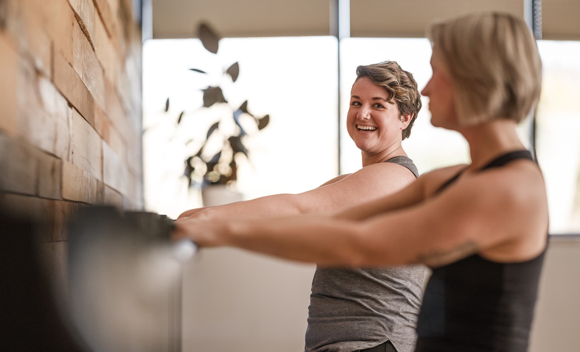 Women connect in barre fitness class