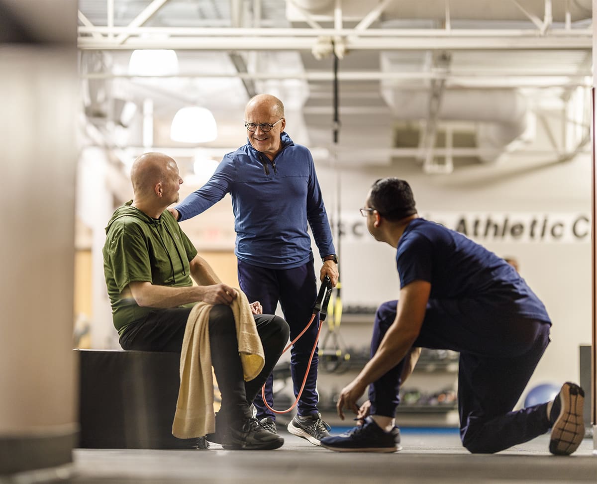 Adult men gather after a workout at fitness center