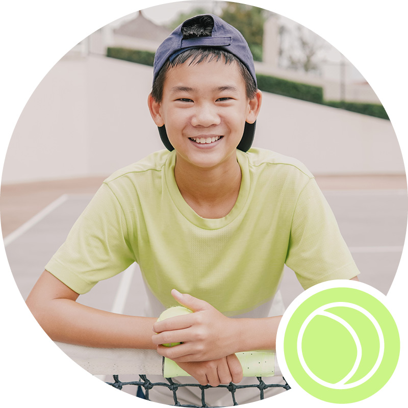 Young boy learns to play tennis summer tennis camp