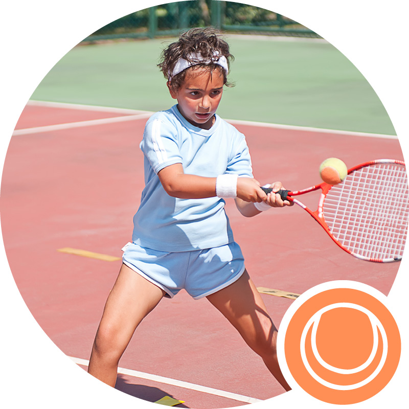 Child learning to play tennis