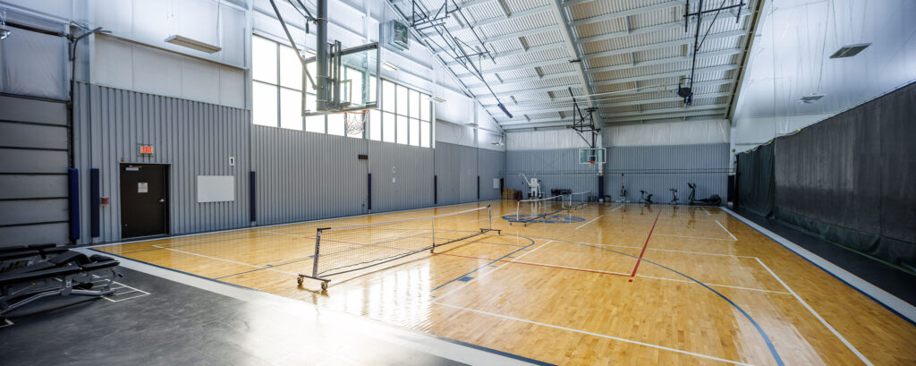 Basketball court gym with pickleball nets at WAC Lake Country