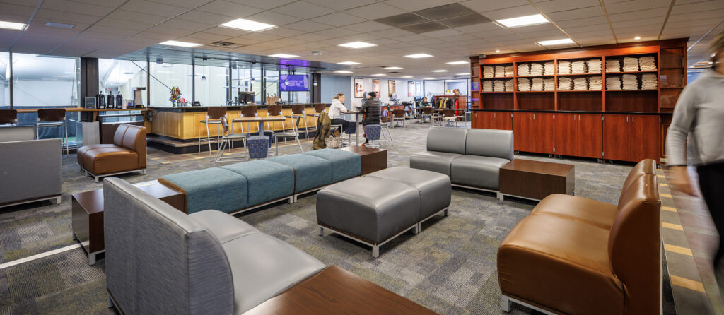 Lobby and club pub at WAC Lake Country. Lounge with seating towel racks and space to see the tennis courts