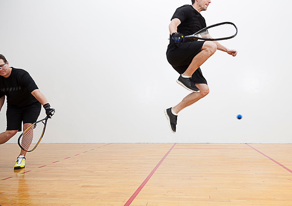 Man jumps playing racquetball