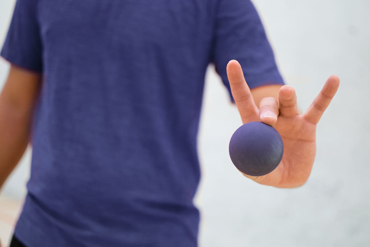 Man holds racquetball ball