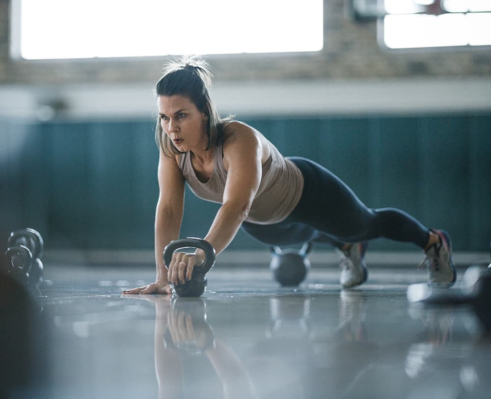 Woman does kettlebell strength workout