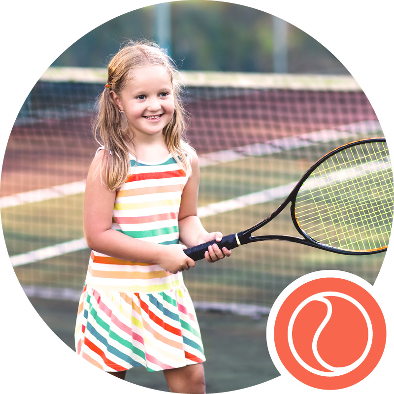 Young girl learns to play tennis at tennis camp