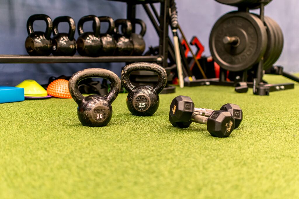 Kettlebells and weights on turf training area