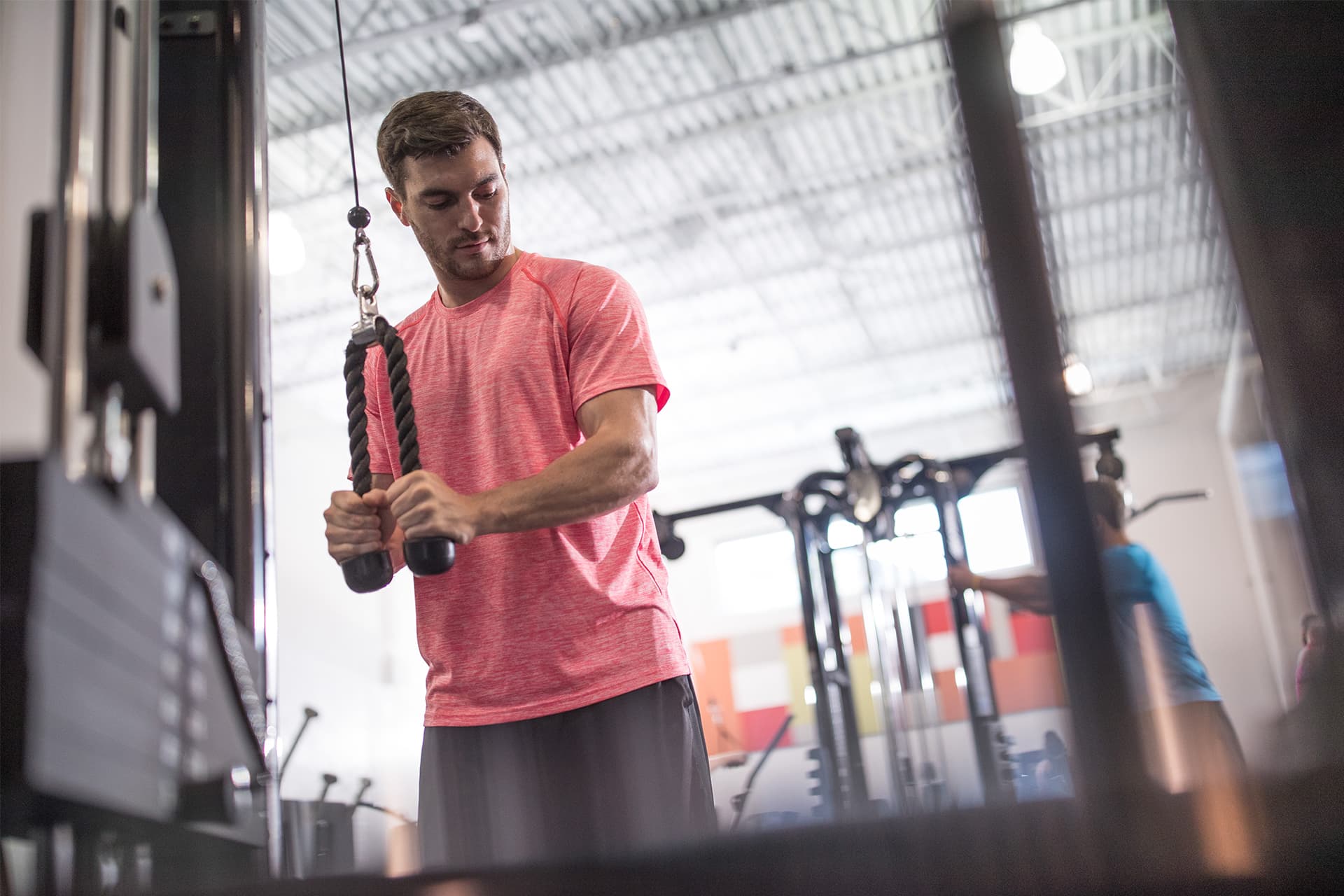 Man does pulley workout at fitness center